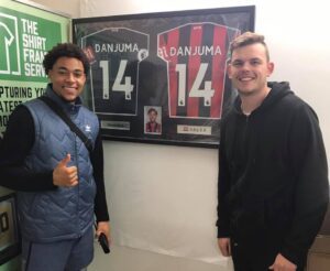 Danjuma with framed shirts